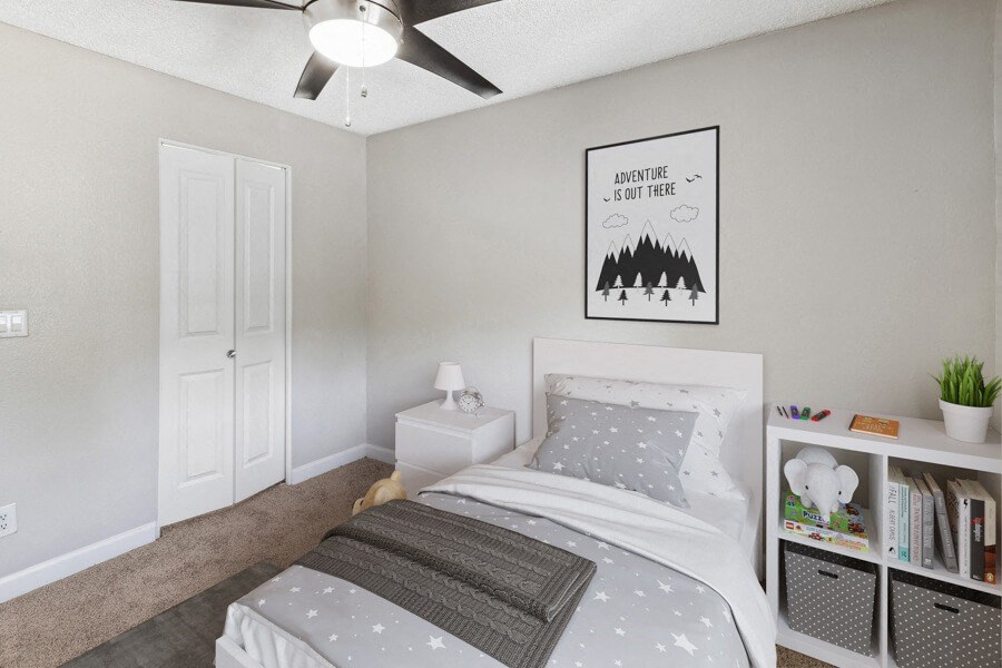 a bedroom with a bed and a ceiling fan